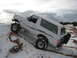 1996 Ford Bronco - A white 1996 Ford Bronco navigates a snowy incline, its off-road capabilities.