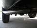 1995 GMC Sierra 1500 - The exhaust system and rear wheel are visible from a low angle beneath the vehicle.