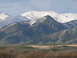 2006 Ford E350 - A vast landscape snow-capped peaks and green hills under a cloudy sky.