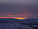 2006 Ford E350 - Winter sunset over a snow-covered valley with mountains on the horizon.