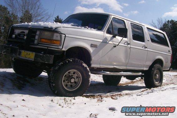 1992 Ford C-350 (Centurion Conversions) parked in snow, front bumper has a smiley face sticker