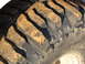1995 Ford Bronco - Muddy off-road tire tread detail.