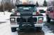 1979 Ford Bronco - Front view of a black 1979 Ford Bronco equipped with a snow plow and auxiliary lights, parked outdoors in a snowy environment.
