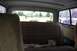 1979 Ford Bronco - View from the back seat of a 1979 Ford Bronco, showing the interior and a snowy landscape with other vehicles outside.