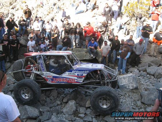 Off-road buggy with Lucas Oil sponsorship navigating rocks