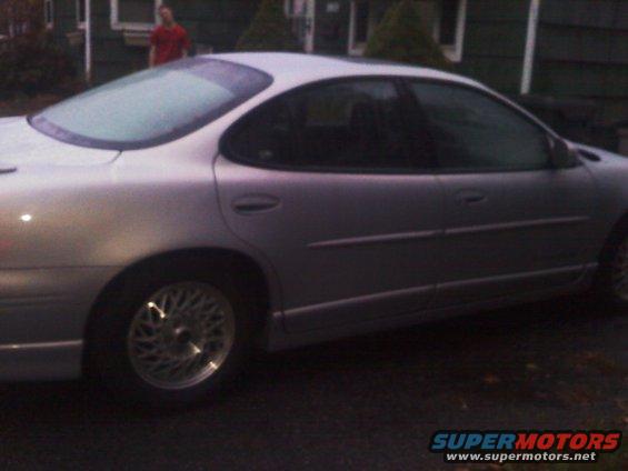 Silver 2000 Pontiac Grand Prix sedan, side view. Frost on rear window