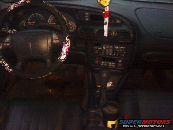 Interior of a 2000 Pontiac Grand Prix showing the steering wheel, dashboard, and center console