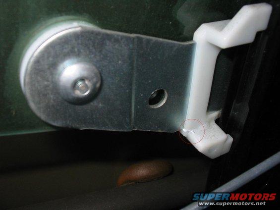 Door window regulator mechanism with white plastic clip and metal bracket