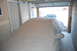 2002 BMW M3 - A car is covered by a tarp in a garage, with another vehicle partially visible outside.
