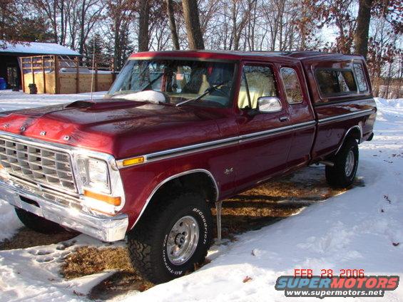 Maroon 1979 Ford F-150 with camper shell in snow