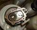 1999 Kawasaki H2C - A turbocharger part is shown with visible impeller blades and mounting flange. Two cylinders are in the background.