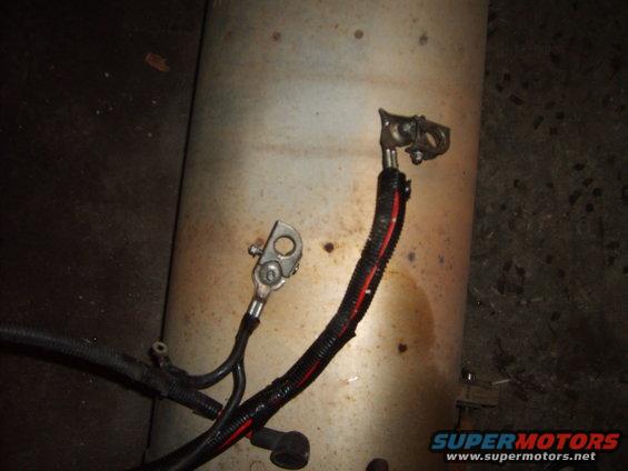 Battery cables connected to a metal cylinder