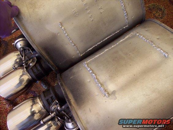 Two exhaust mufflers with quad tips, showing GM part number 89068