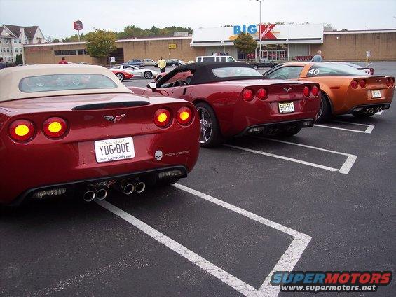 Red convertible Corvette with quad exhaust and license plate YDG-80E