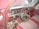 1985 Ford Bronco - The interior of this older truck shows a worn dashboard and cracked windshield.