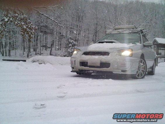 Silver Subaru Impreza WRX in snow with roof rack