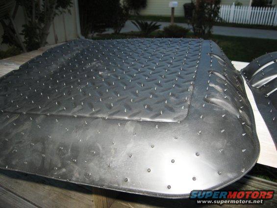 Rubber floor mat with diamond plate texture and many small spikes