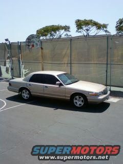 Gold 1997 Mercury Grand Marquis parked on a basketball court