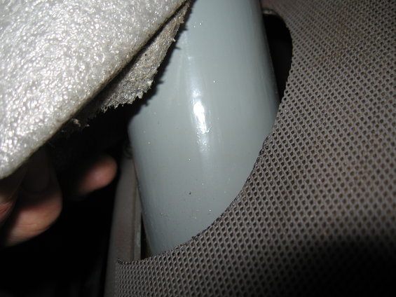 Gray roll bar with black strap against a textured surface