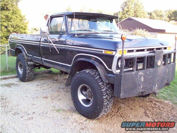 Black 1977 Ford F-250 pickup truck with a brush guard and lifted suspension