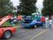 1978 Pontiac Trans Am - Two Pontiac Trans Ams, one blue and one red, are displayed with their hoods and trunks open at an outdoor event.