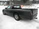 1972 Ford Ranchero - This black pickup truck is viewed from the rear quarter in a snowy environment.