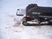 1990 Arctic Cat El Tigre EXT - Side view of an Arctic Cat snowmobile with visible 'Arctic Cat' branding and green track wheels.
