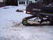 1990 Arctic Cat El Tigre EXT - Arctic Cat snowmobile parked in a snowy area with a house in the background.