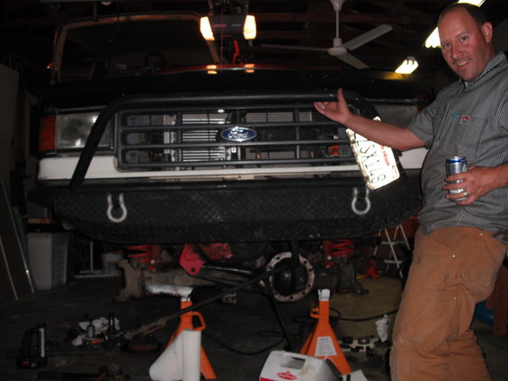 1991 Ford Bronco front end with custom bumper and man holding license plate