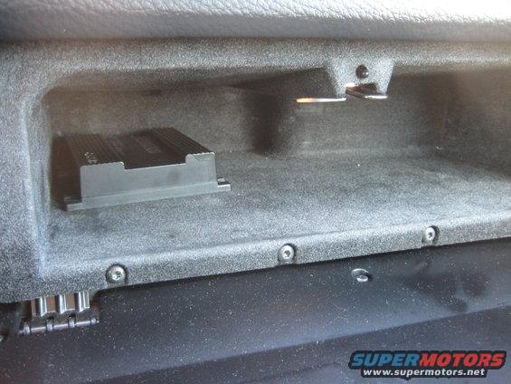 Glove box interior with black amplifier unit