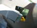 2003 Ford Crown Victoria - Close-up view of a vehicle's interior door panel, showing a yellow and red clip mechanism.