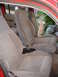 1992 Ford Explorer - The interior of a vehicle shows two front seats with gray fabric upholstery and visible seatbelts.