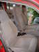 1992 Ford Explorer - The interior of a vehicle shows gray fabric seats and seatbelts, with a flashlight visible on the floor.