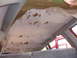 1992 Ford Explorer - The headliner in this vehicle is peeling and torn, revealing the underlying material.