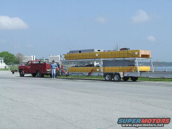 Red 1978 Ford F-250 side view towing a trailer