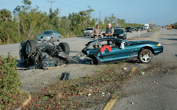 two vehicles pulled over on the side of a road, one appears to be a truck towing another vehicle