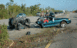 1978 Ford Mustang II - Two vehicles are stopped on the side of a road, with one appearing to be a truck towing another vehicle.
