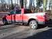 2009 Ford F-150 - Side view of a red 2009 Ford F-150 FX4 pickup truck.