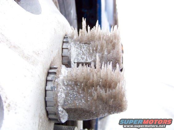 Close-up of ice formations on a metal vehicle part