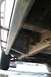 2000 Chevrolet Tahoe - The underside of a vehicle, showing the frame and slider bars, with another car in the distance.