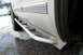 2000 Chevrolet Tahoe - The side of a dirty 2000 Chevrolet Tahoe with aftermarket side step bars is shown in this close-up, with a second vehicle visible in the ba…