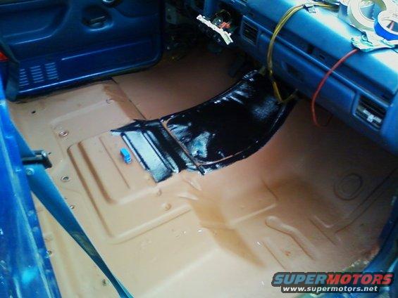 After taking out all of the body panels, carpeting, and speaker wires, and sanding and preping the floor I put down a coat of primer.