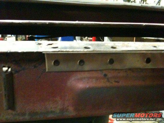 Close-up of rusted metal frame with visible rivets