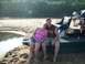 1979 Ford F-250 - Couple relaxing on a boat dock next to a river on a sunny day.
