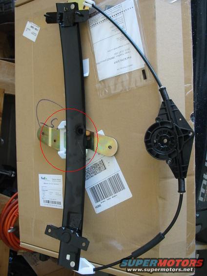 Window regulator mechanism with cable and motor assembly, on a cardboard box