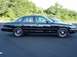 1996 Ford Crown Victoria - Side profile of a black 1996 Ford Crown Victoria sedan parked next to another vehicle.