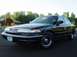 1996 Ford Crown Victoria - Front 3/4 view of a black 1996 Ford Crown Victoria sedan parked on asphalt.