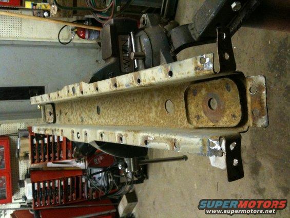 Rusted metal frame part with mounting holes and brackets