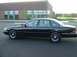 1996 Ford Crown Victoria - A black 1996 Ford Crown Victoria sedan is parked in front of a modern brick building.