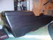 1973 Ford Ranchero - A black car center console sits on a table, showing its storage area and angled design.